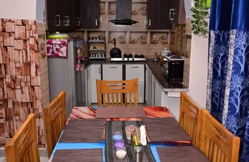 Rajgarhi House | Peaceful stay : 2-bedroom, bright living area, kitchen, terrace, and garden