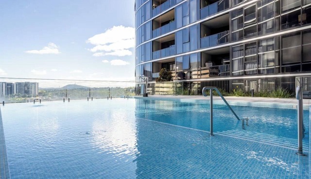 Elegant 2BR Retreat with Pool, Parking and Balcony